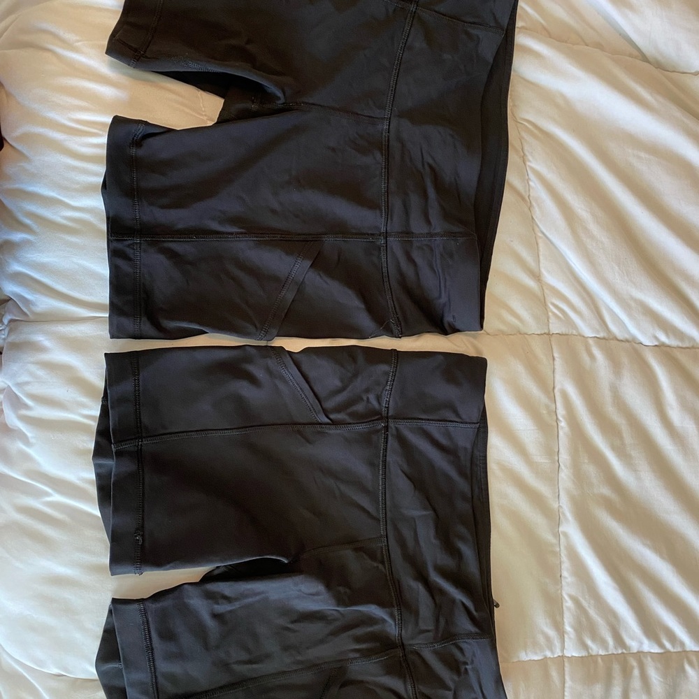 2 black Lululemon bikes shorts with pockets